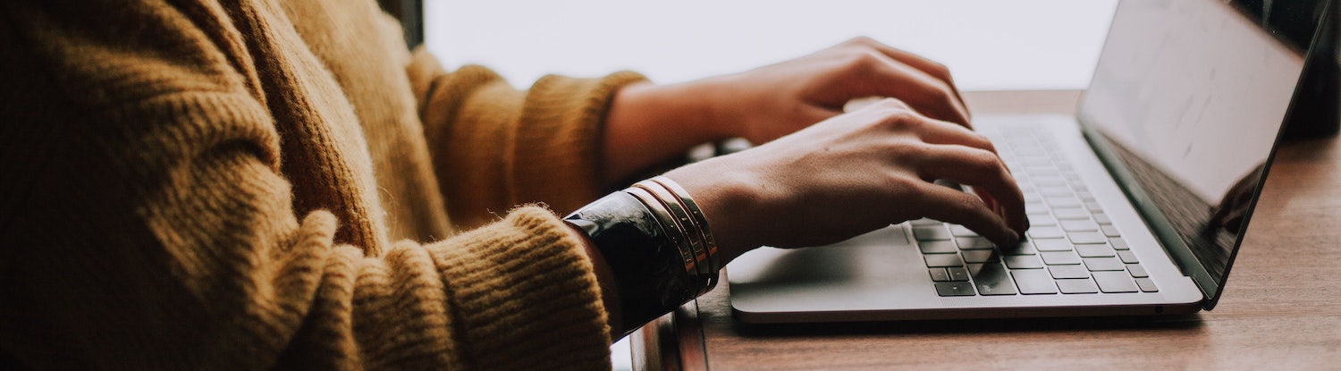 Photo of someone typing on a laptop